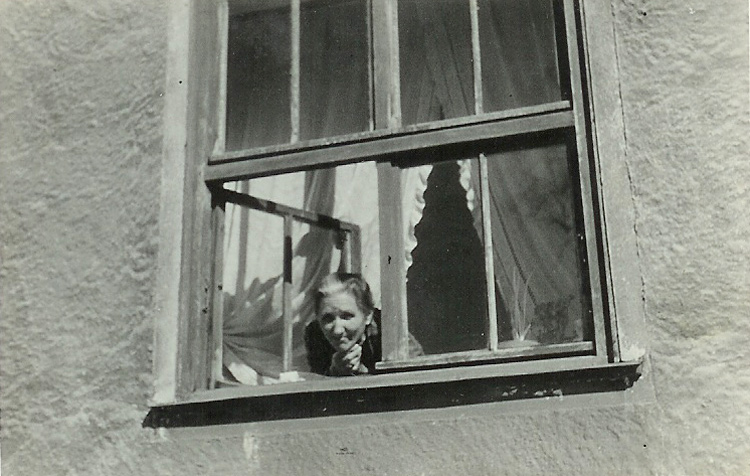 Terēze Skariņš skatās no savas istabas loga 